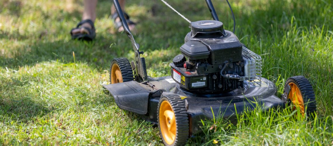 Photo of a lawnmower cutting tall grass.