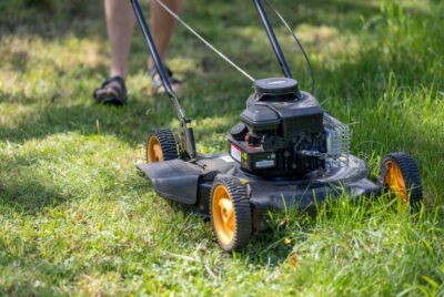 Photo of a lawnmower cutting tall grass.