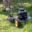 Photo of a lawnmower cutting tall grass.