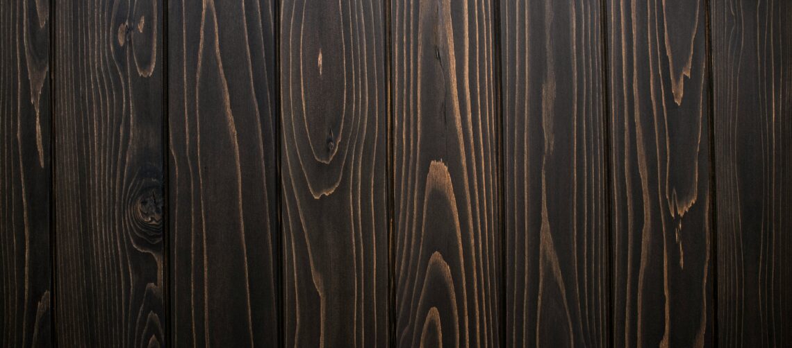 Photo of dark strips of wood with grain showing.