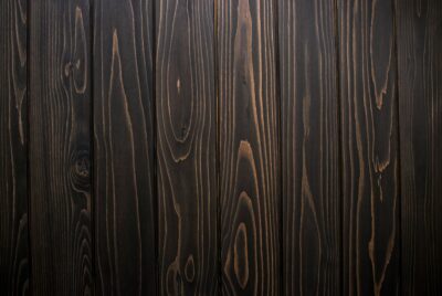 Photo of dark strips of wood with grain showing.